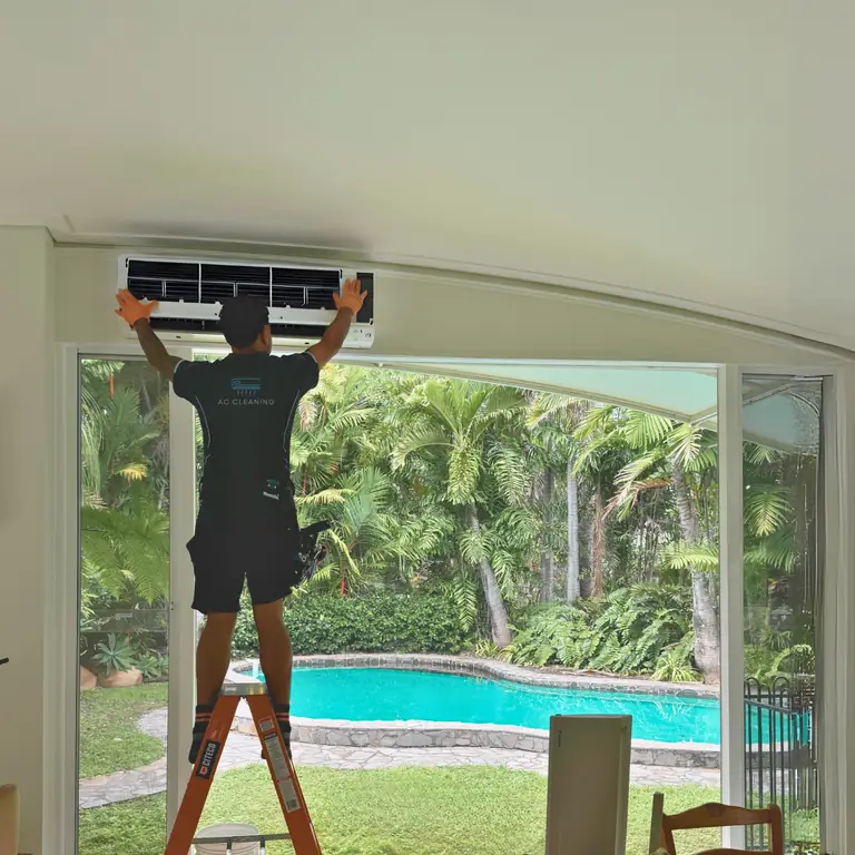 Chilled Out technician cleaning a wall-mounted split system in a Townsville home